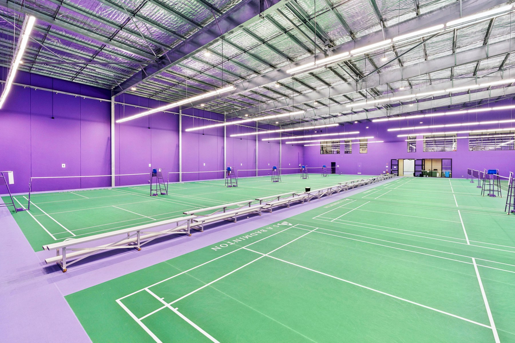 Green badminton courts inside the Enfield hall